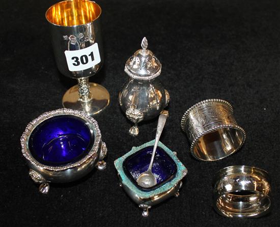 George V silver three piece condiment set, two silver napkin rings and a silver match stand